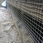 Screening off a deck to exclude raccoons. Carmel-by-the-Sea.